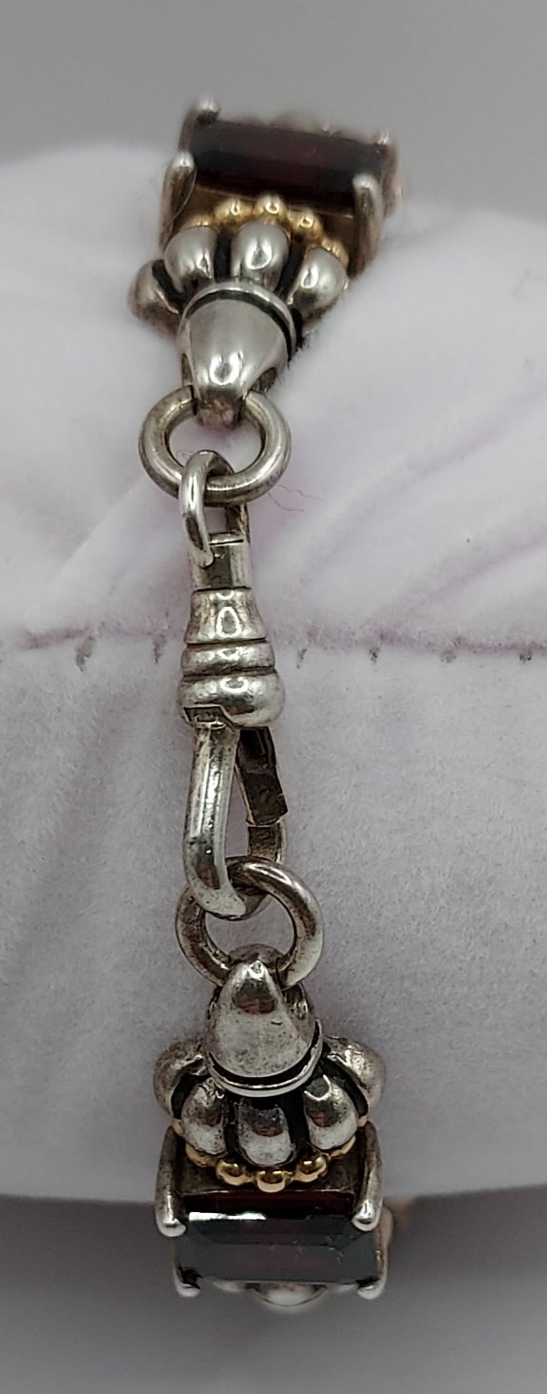 Sterling 5-segment bracelet w/square garnets and gold accents.  Swivel hook clasp.  Marked CID, 925 14K  Maker Clyde Dunier