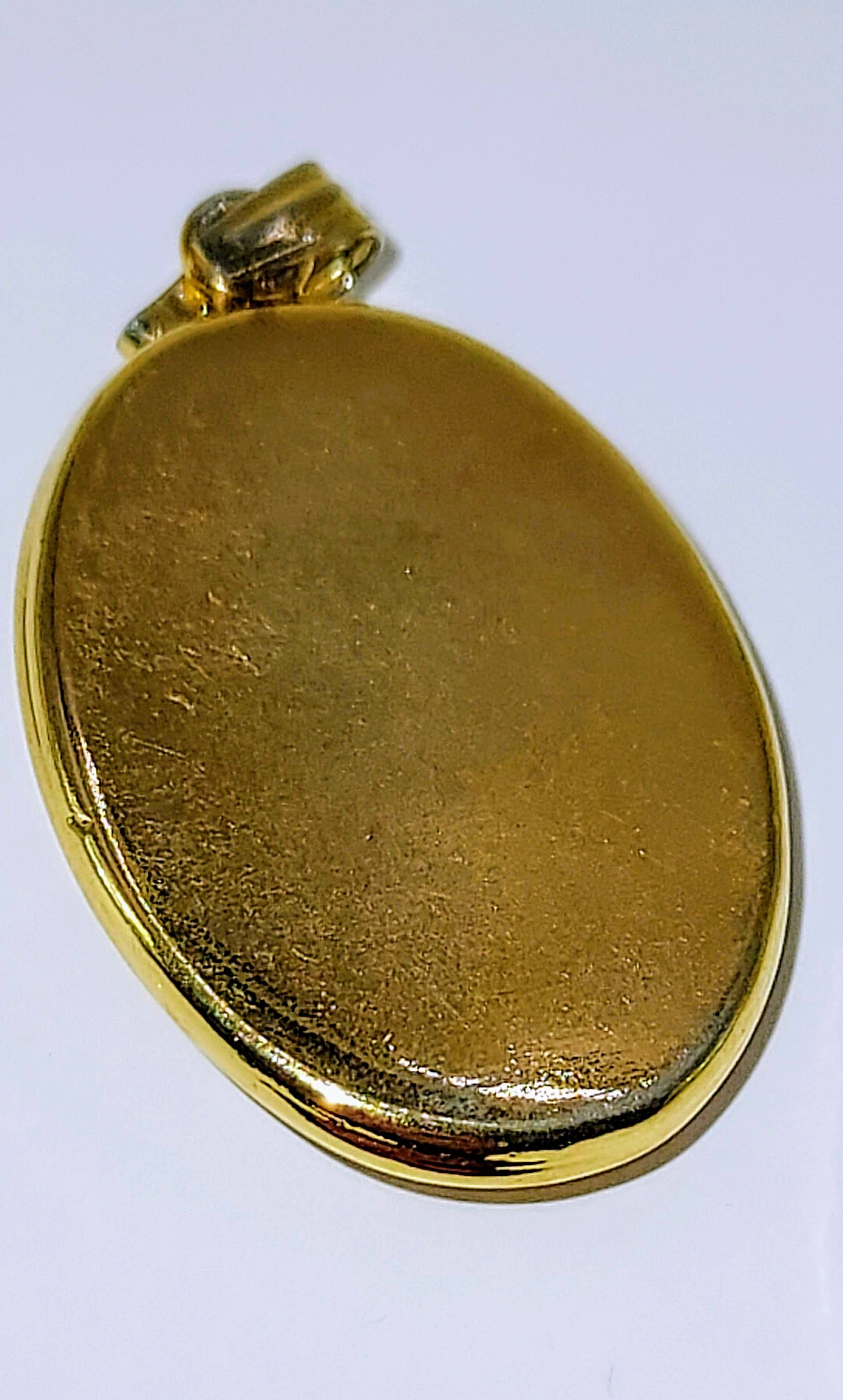 Oval Shell Cameo set in gold bezel.  Young female profile w/blossoms