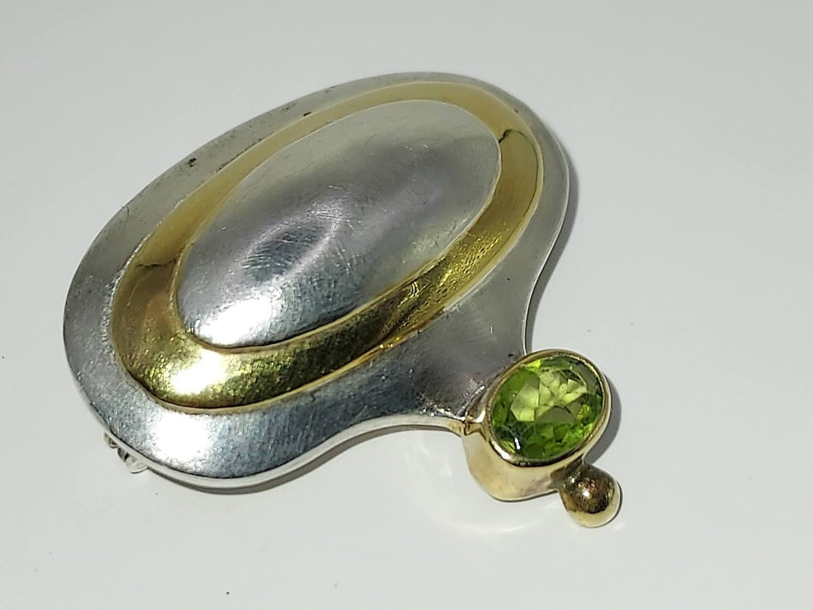 Modern silver and gold with peridot pendant/pin back